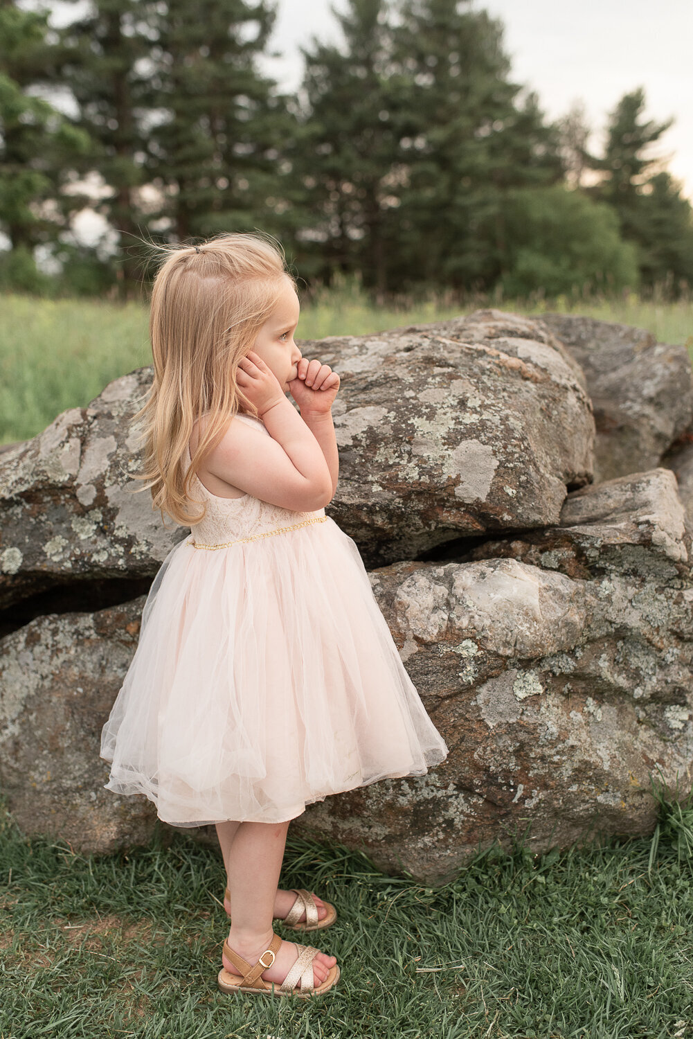 Little girl sucking thumb and looking out over field in Litchfield, Connecticut |Sharon Leger Photography | Canton, CT Newborn & Family Photographer