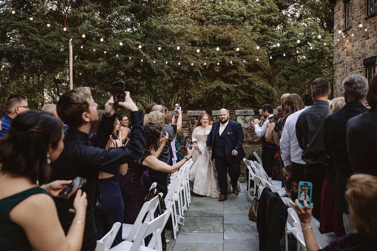 Newlyweds walking back up the aisle after their ceremony 