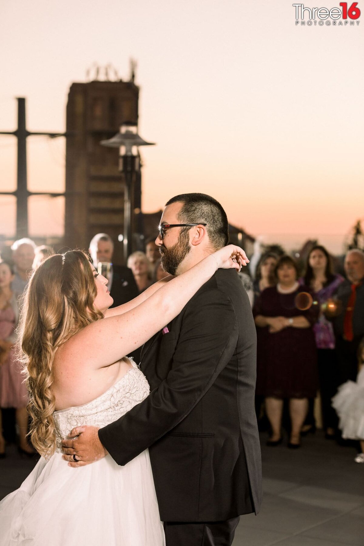 Bride and Groom share their first dance as the sun is about to set on the rooftop at The FIFTH Rooftop Restaurant & Bar