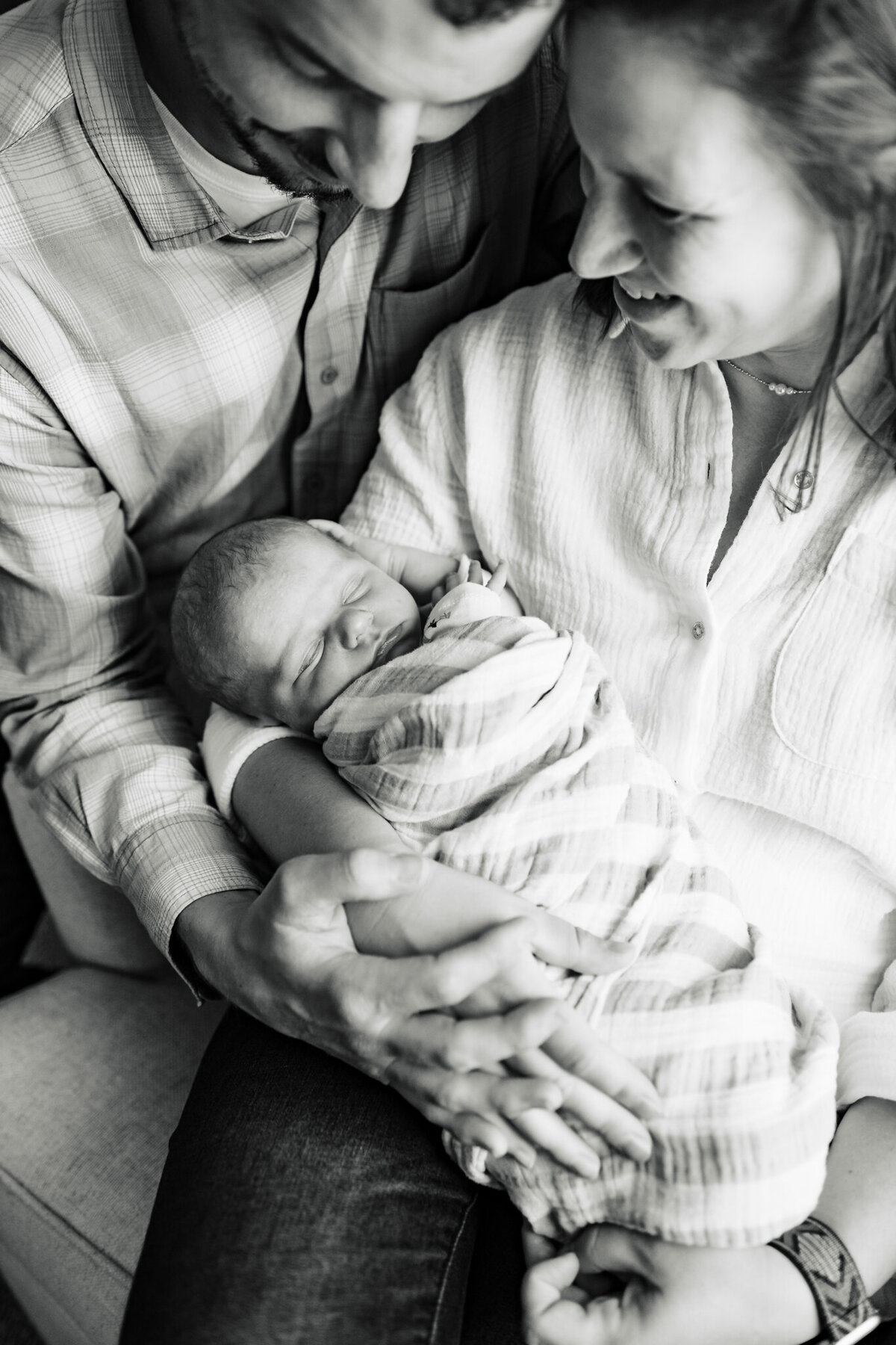parents together holding baby professional photography at home