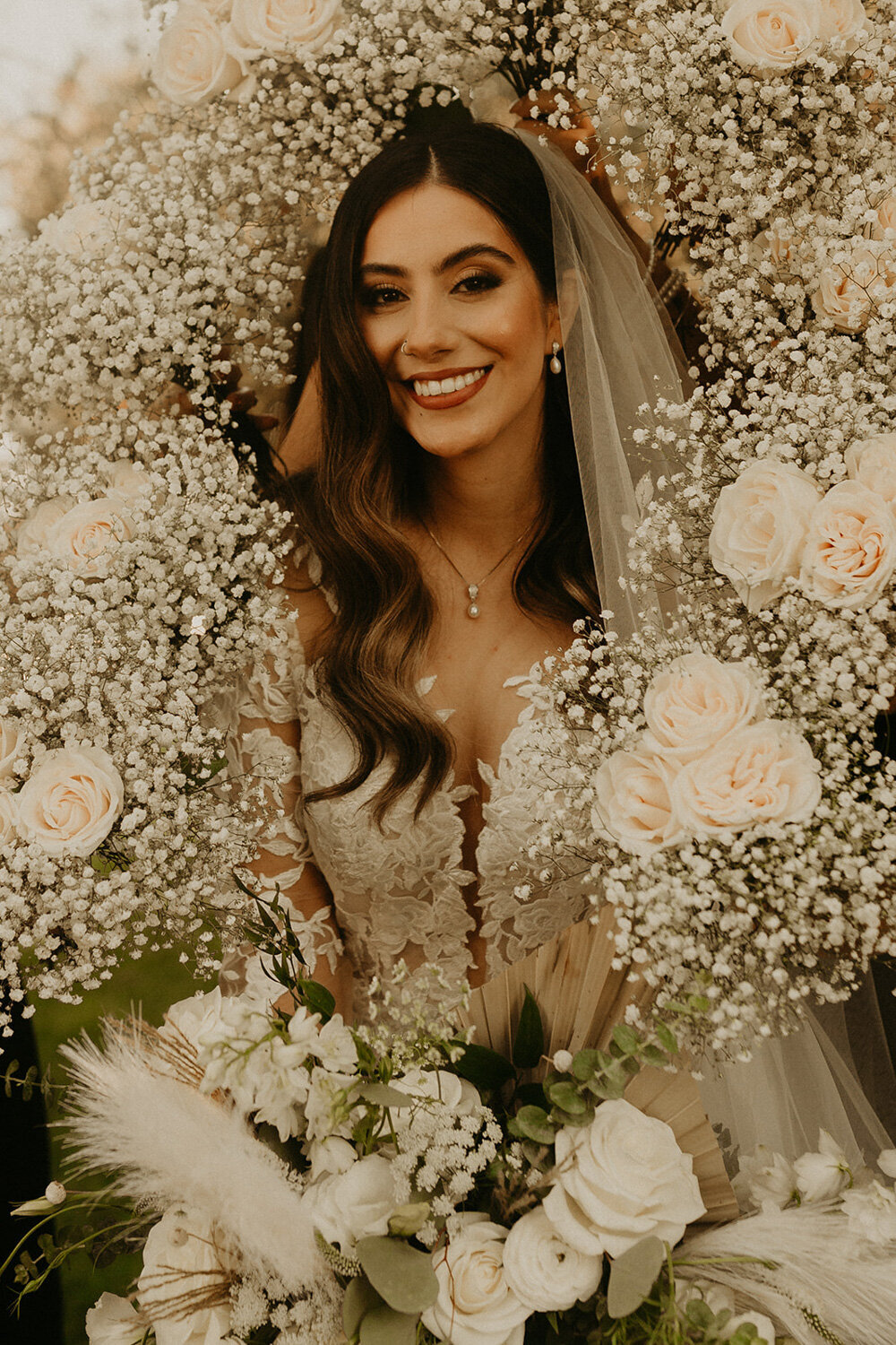 Beautiful bride surrounded by elegant flowers