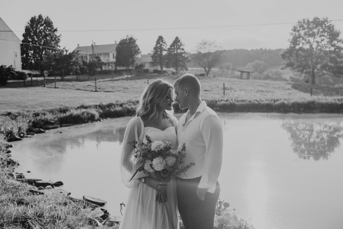 bride and groom standing next to each other in front of pond in Eufala Alabama by Columbus Georgia wedding photographer Amanda Richardson Photography