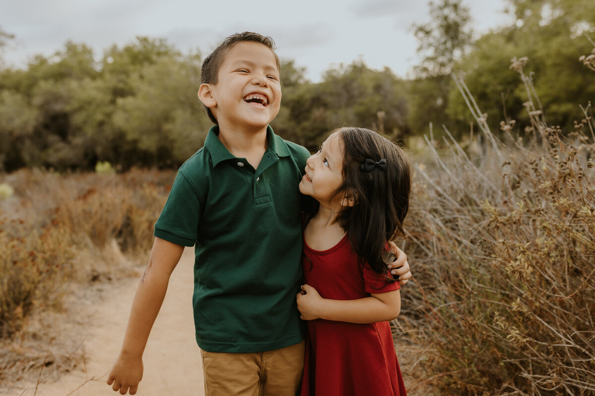 Boy and girl siblings laugh