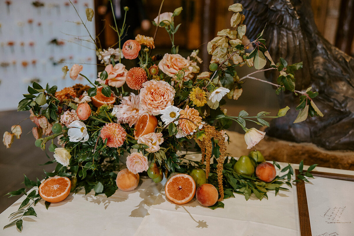 Welcome table with organic harvest florals and  peaches, pears and grapefruit in Sunriver Great Hall