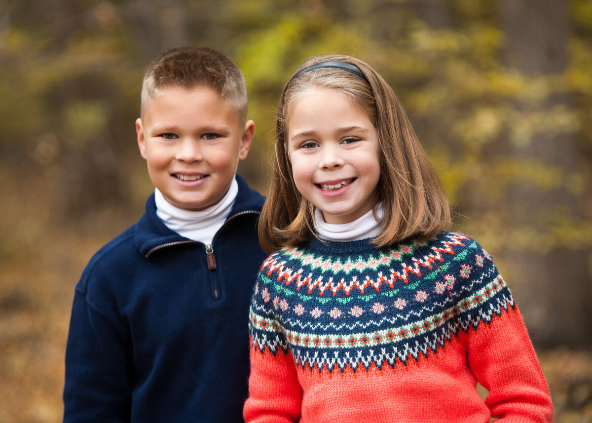 family picture of a boy and a girl in the fall