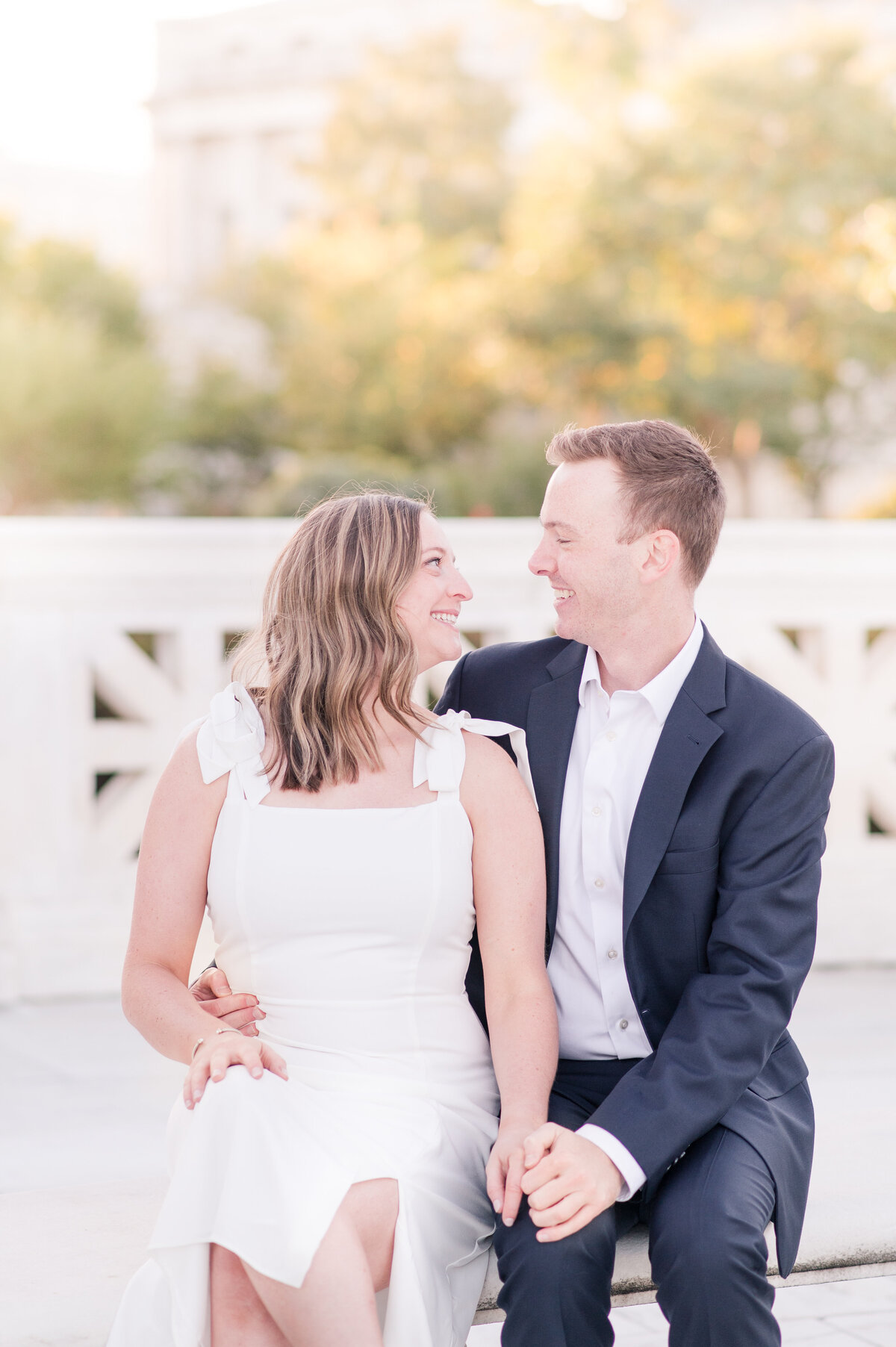 couple sitting on marble bench at sunrise