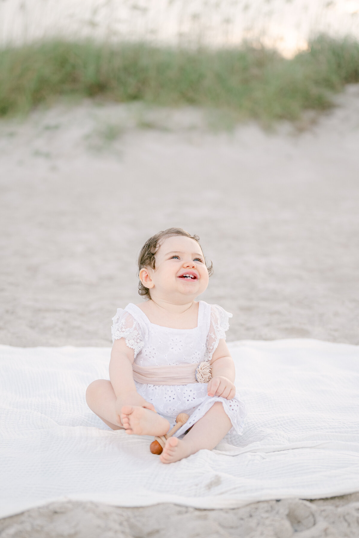 Baby girl laughing on the beach