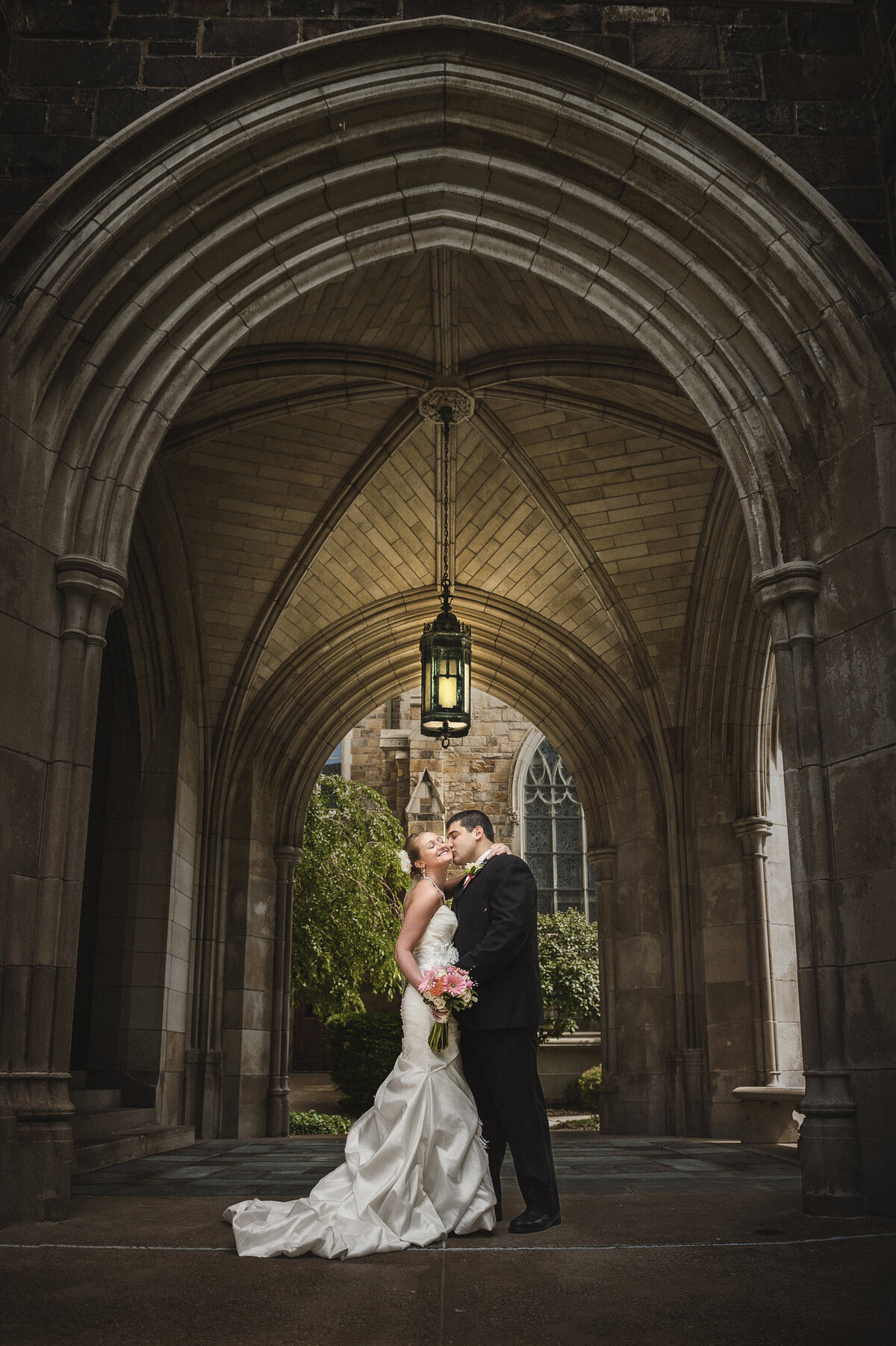 Groom kissing bride after ceremony at church.