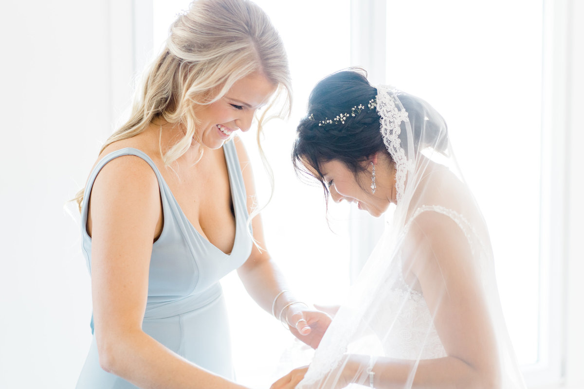 bride-getting-ready-with-bridesmaid
