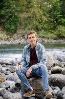 cedar crest high school senior guy sitting on rock at north bend river