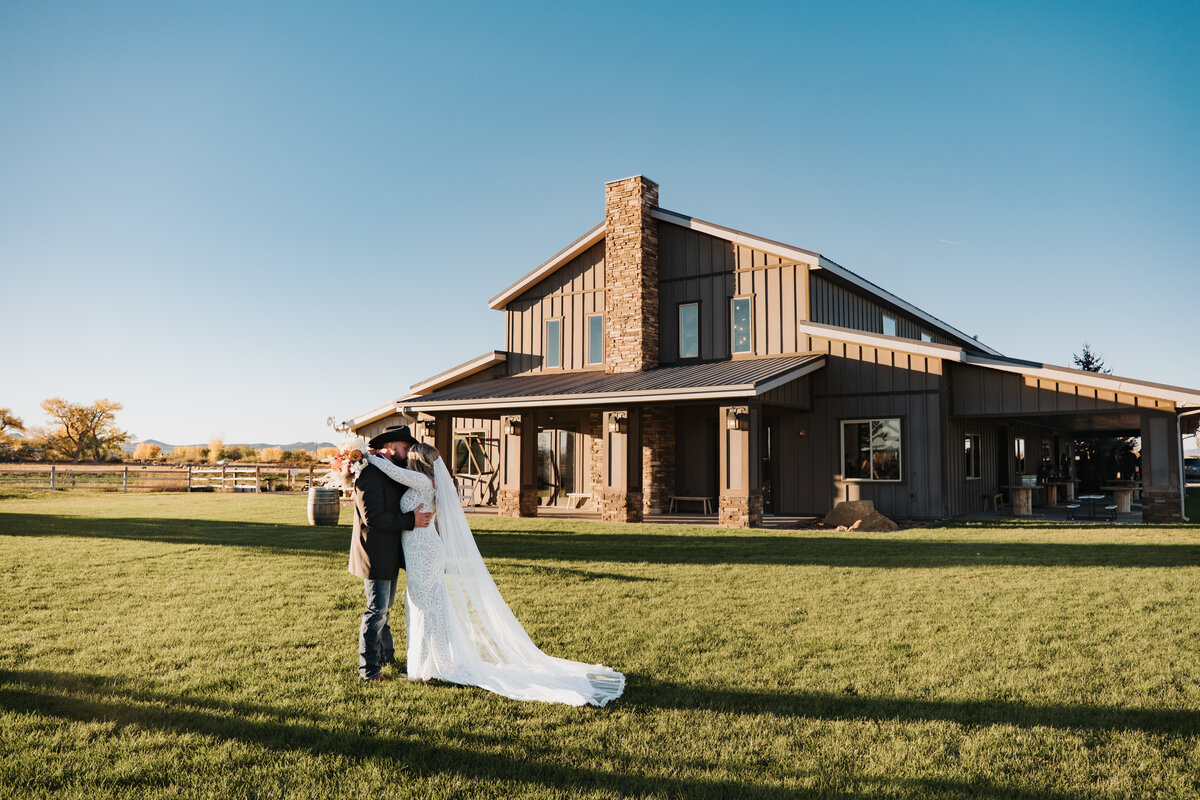 Couple on the lawn in front of the barn