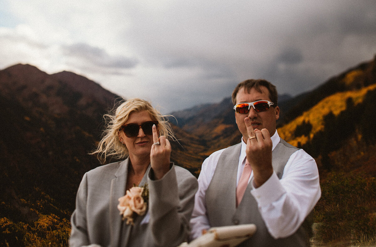 bride and groom show off their wedding rings