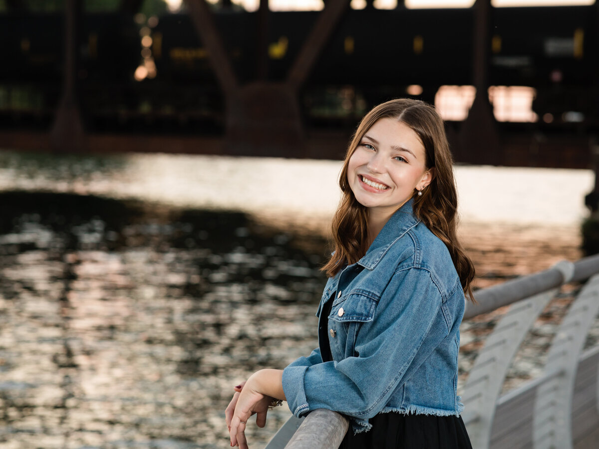 senior girl in black dress posed for senior portraits 