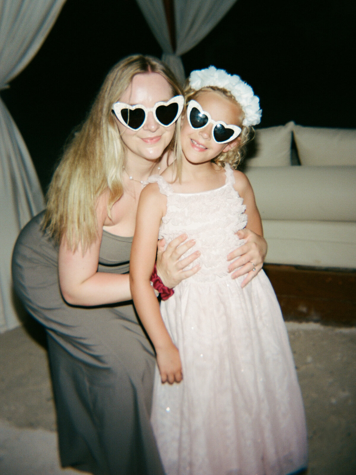 Mom with daughter, heart sunglasses, film photography at Mexico wedding reception in Playa del Carmen