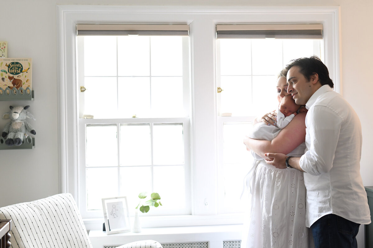 A heartwarming in-home newborn session capturing the love and connection of new parents with their baby. Natural light, soft tones, and a peaceful setting make for timeless newborn portraits in Connecticut.