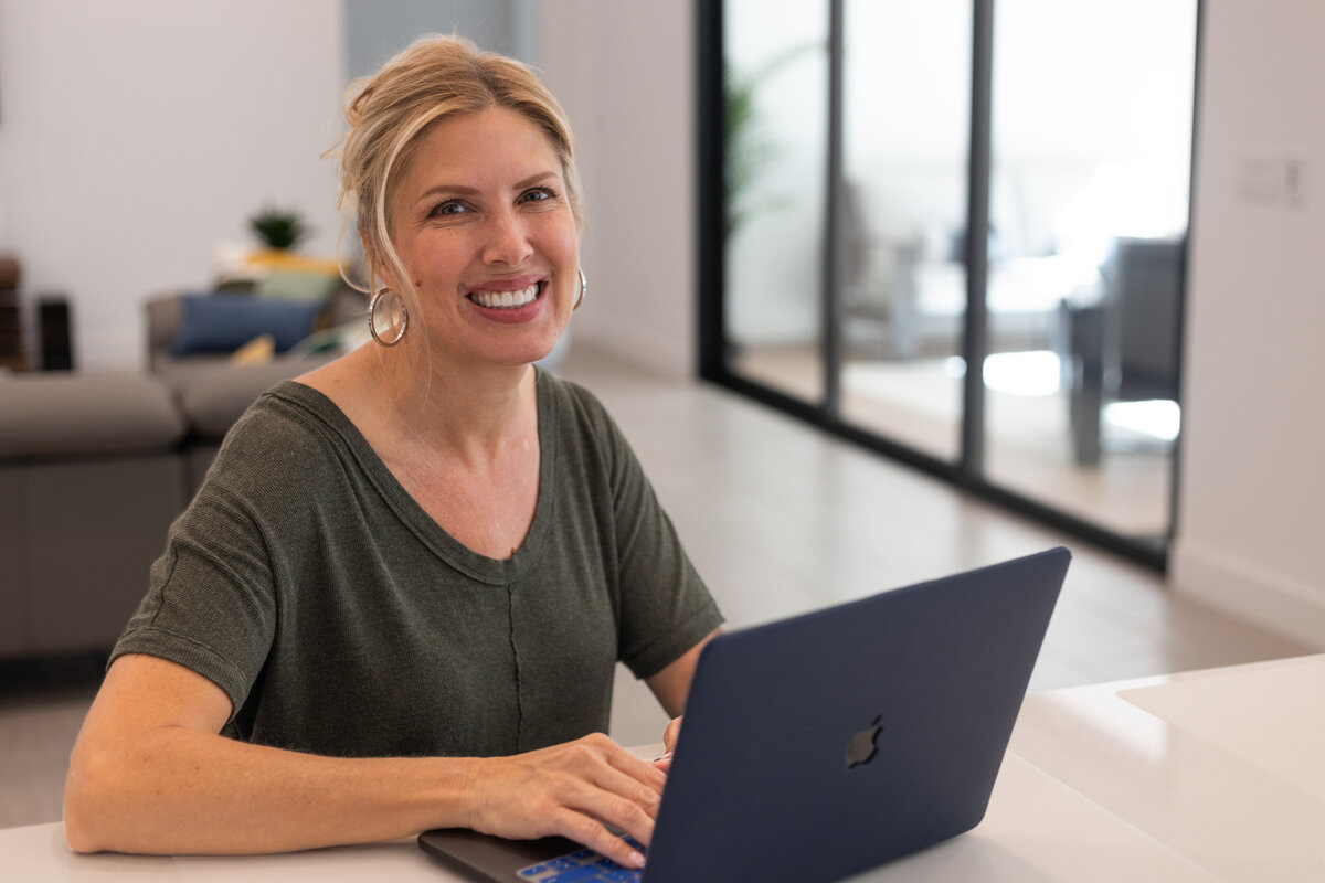 Accountant at home working on her laptop from the kitchen counter