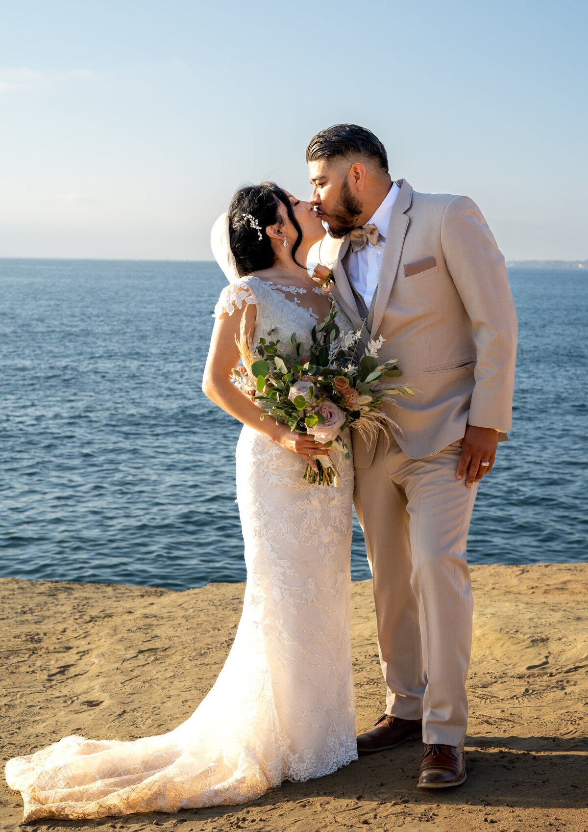 Bride and Groom kiss at Sunset Cliffs