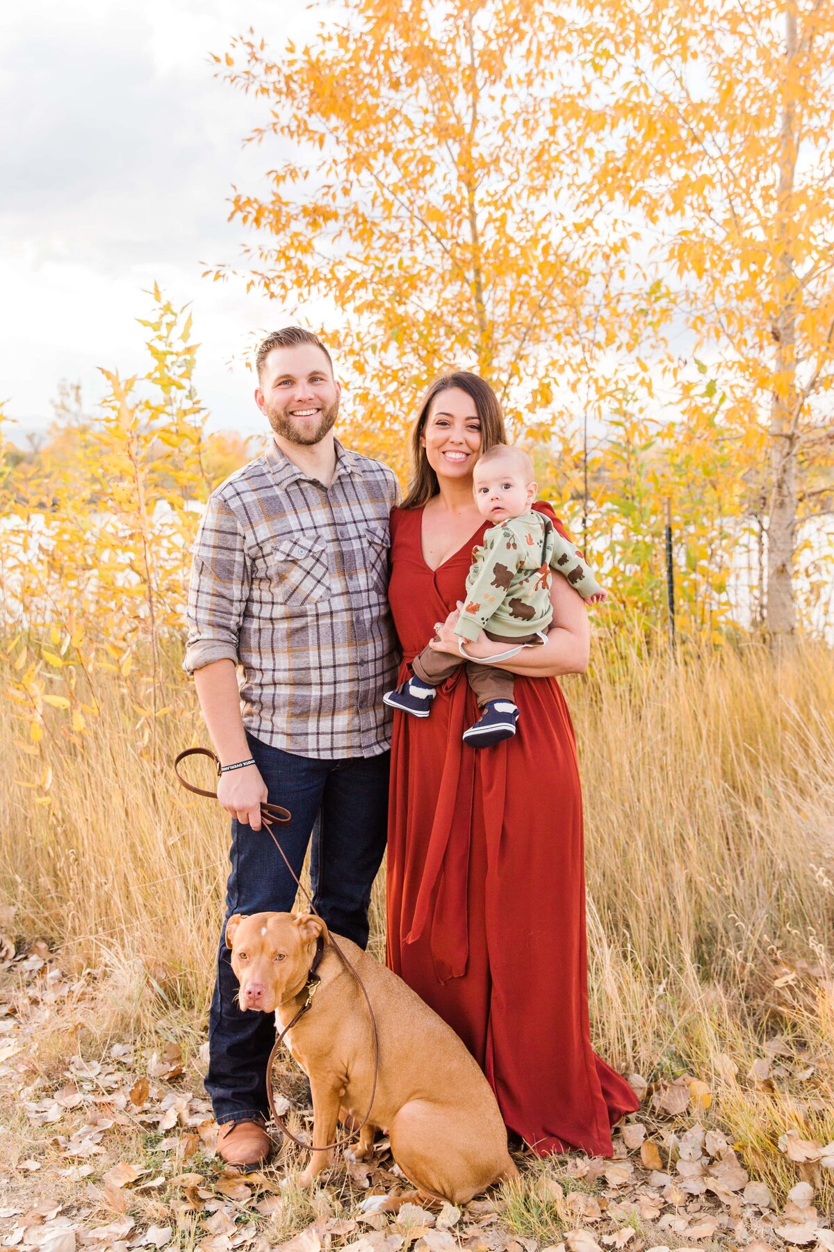 fall family portrait with dog sitting in front