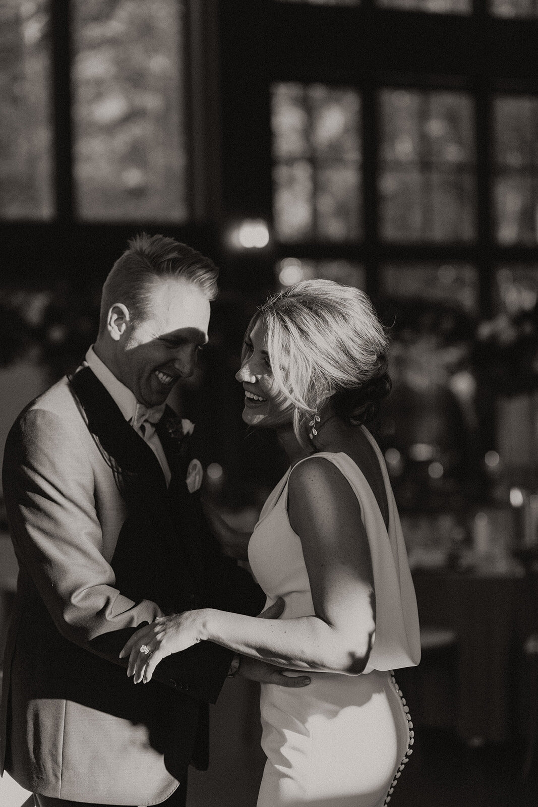 Ryan and Alana daning on their wedding day in a black and white photo