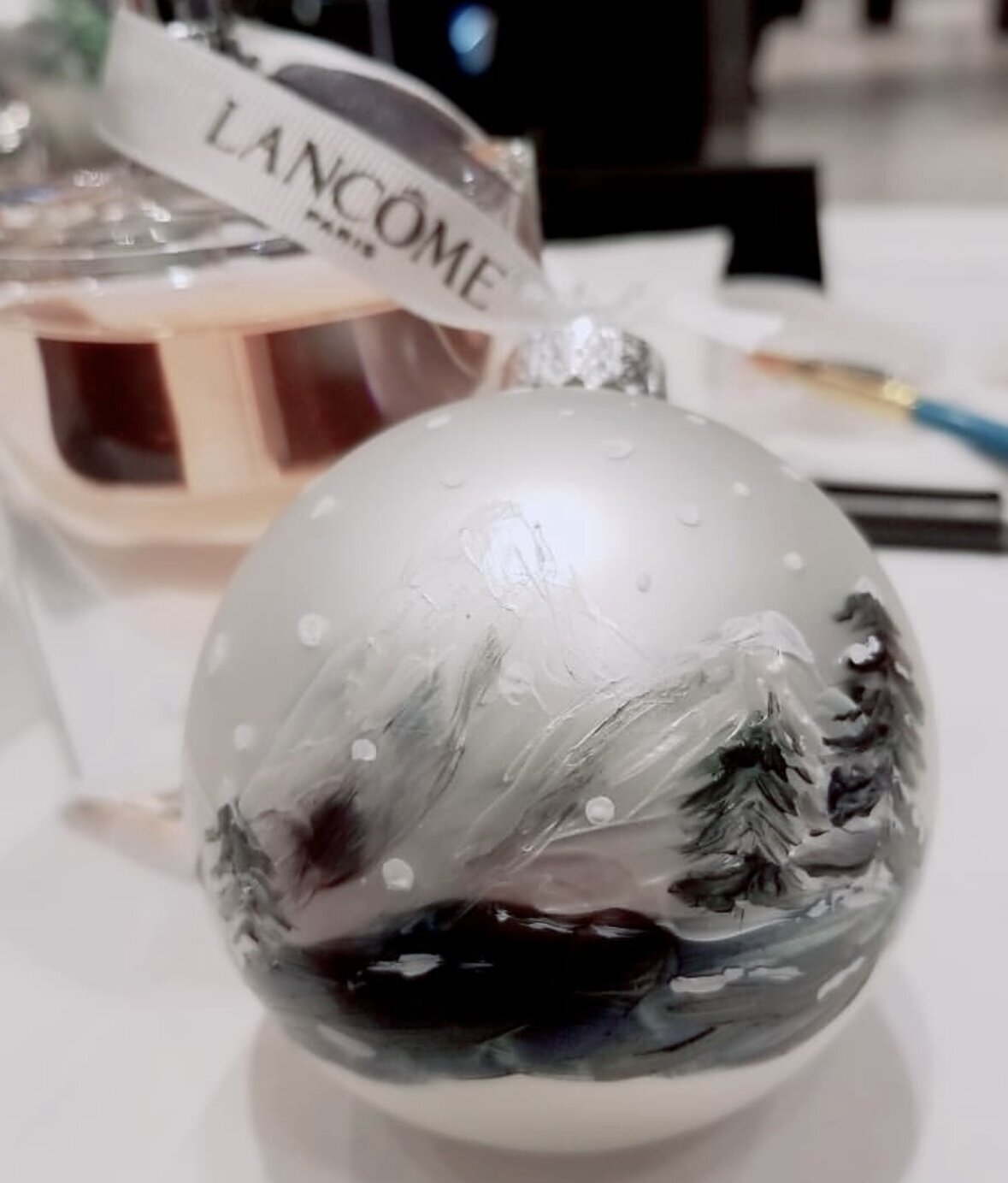 Custom painted Christmas ornaments for Lancome holiday brand activation by Toronto live painter Jenny Zhang