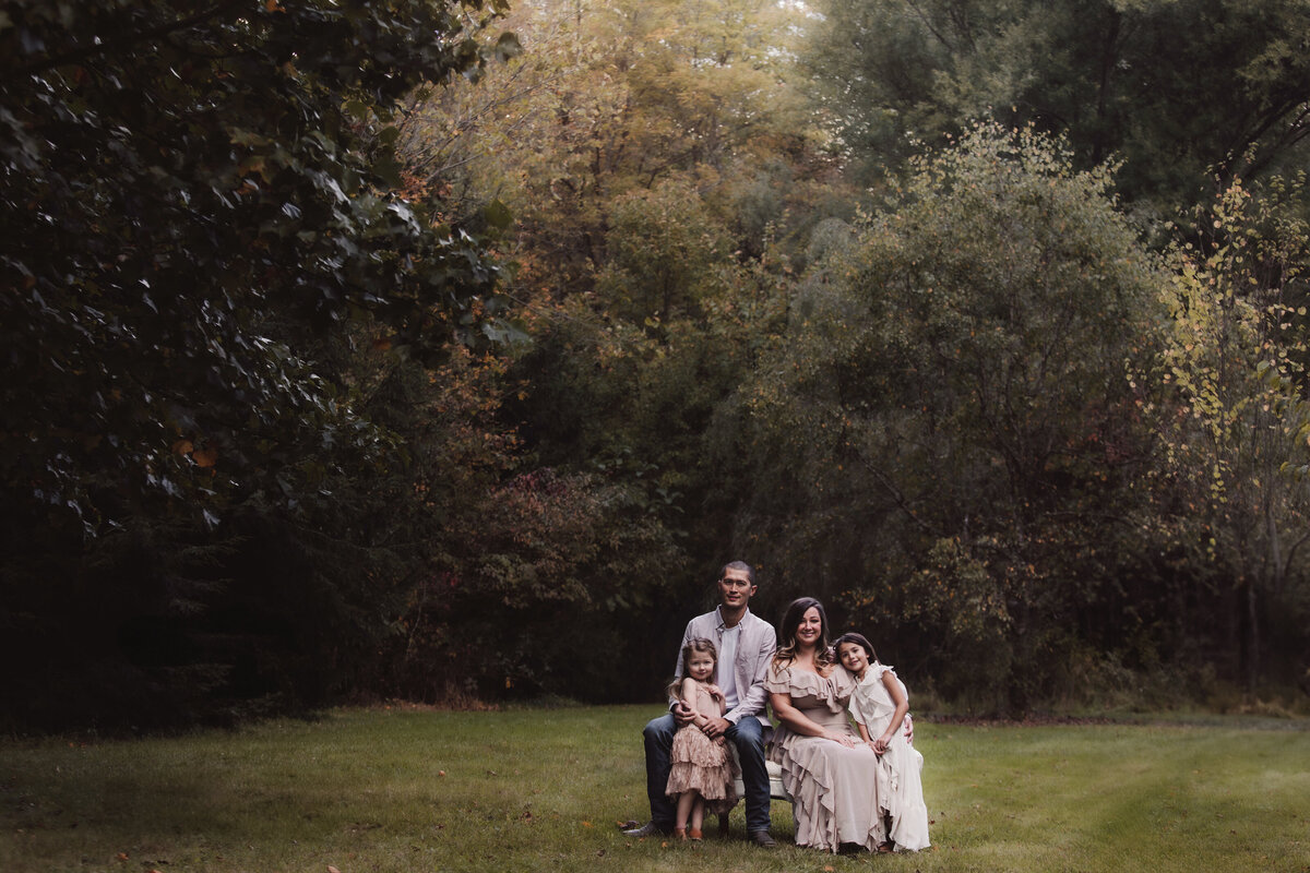 Beautiful Family Seated on Bench in Park
