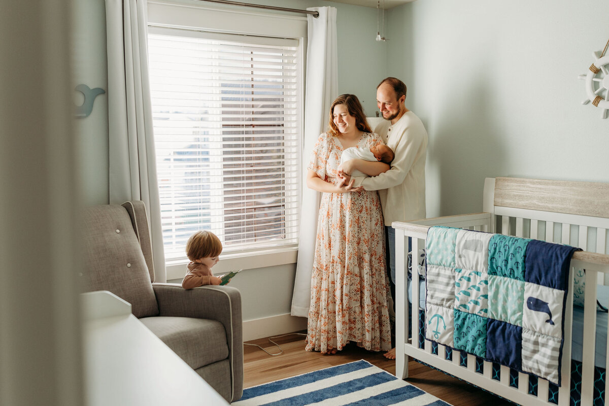 A family stands inside their baby's nursery