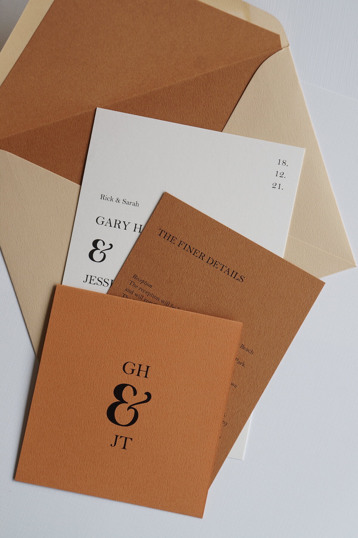 Terracotta and brown wedding invitation suite with buttermilk envelope and bold ampersand symbol