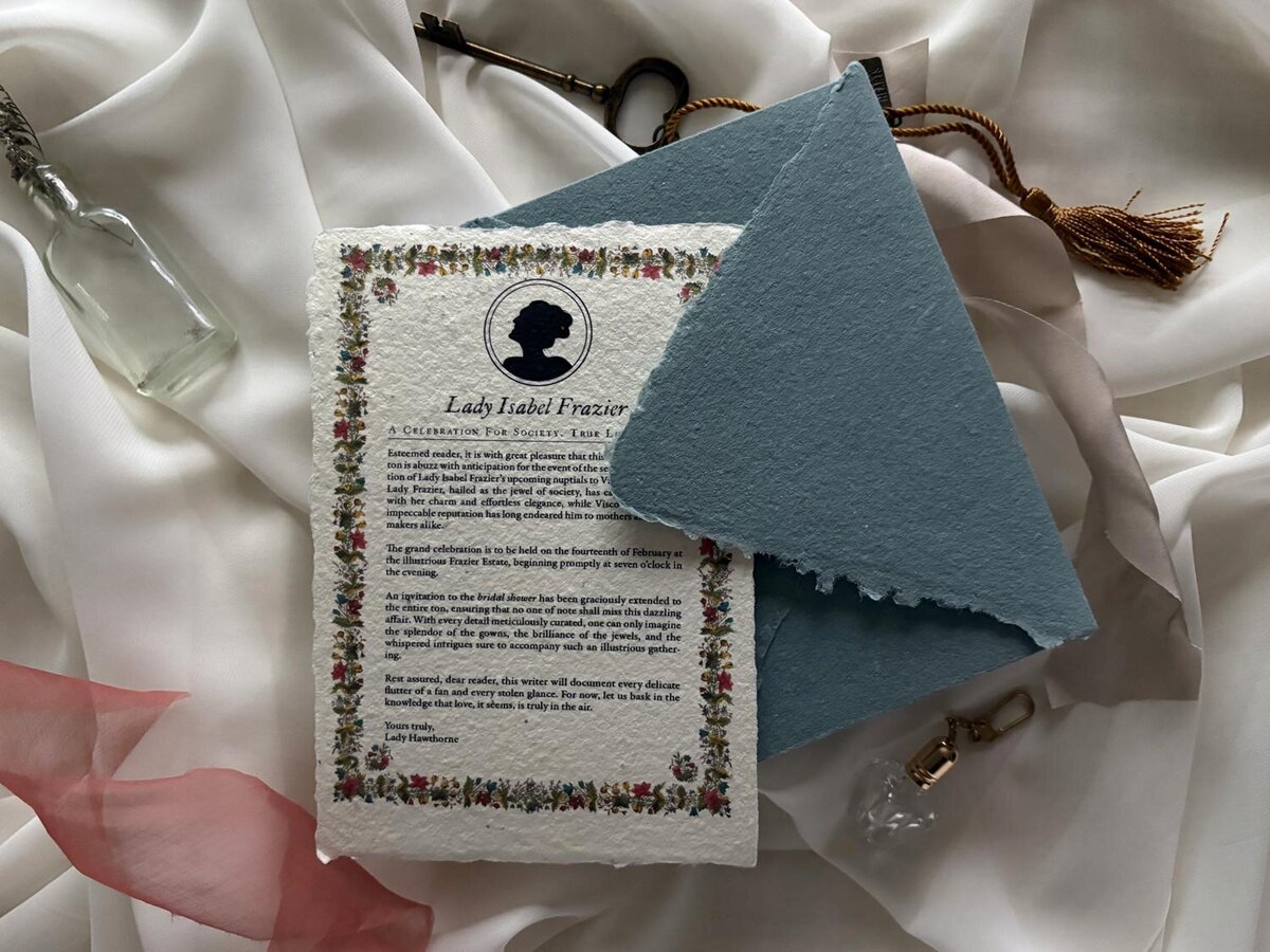 hand dyed baby blue cotton envelope with handmade deckled edge invite and floral illustrations