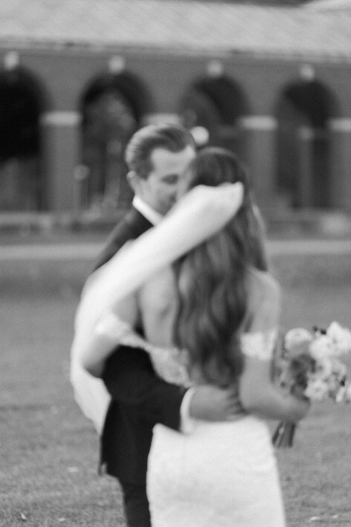 Husband and wife walk through the grass standing side by side