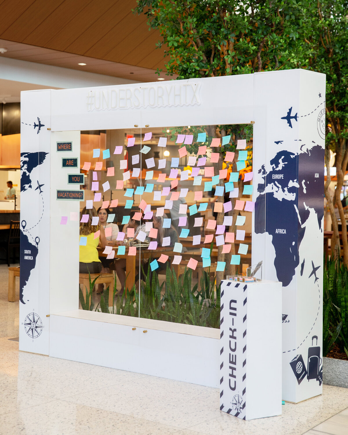 Understory Houston Texas world travel themed corporate event seating chart backdrop display