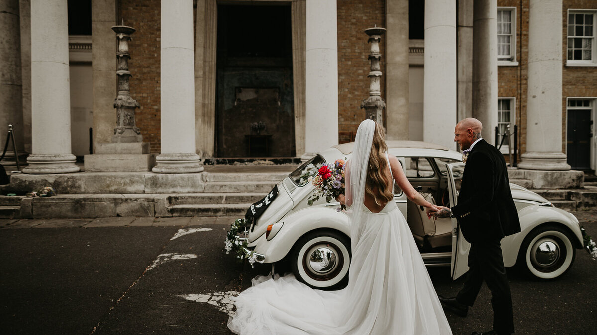 Bride and Groom leave the Asylum Chapel in London in a V.W Beetle.
