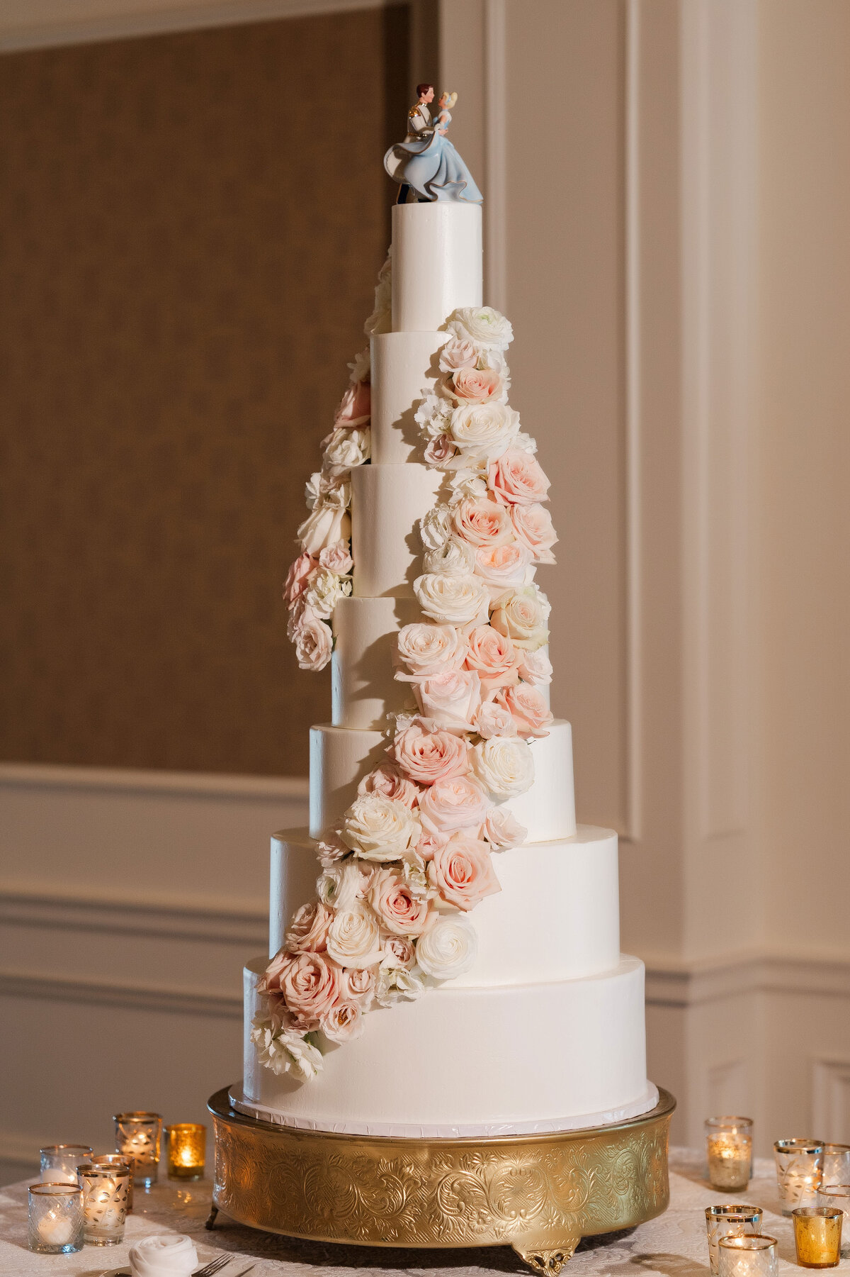 huge flowered wedding cake by tasty bakery at The Grand Resort wedding reception ballroom