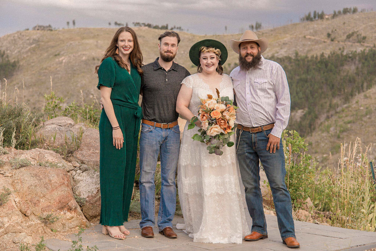 The bride and groom are joined by their witnesses for a photo in the Colorado mountains.