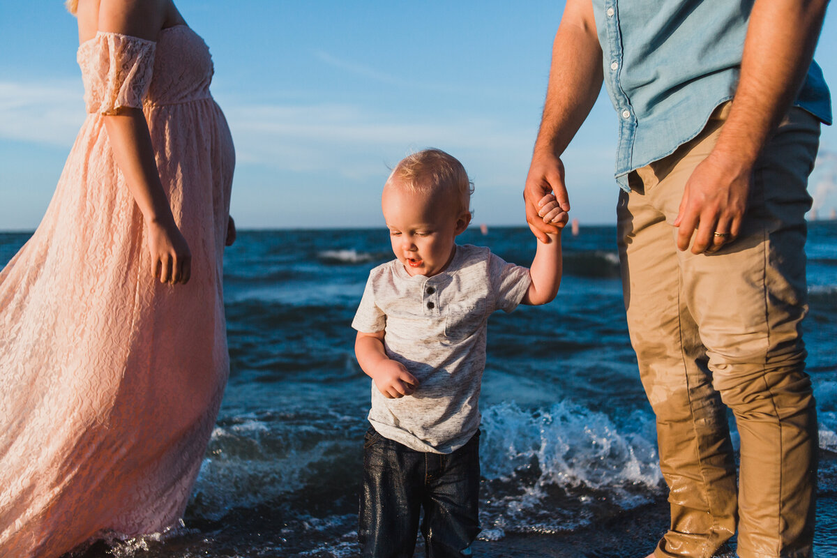 Mom, dad and son at beach in Cleveland, OH during maternity session