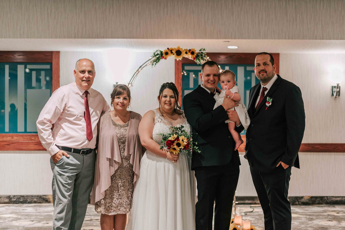 Bride and groom standing with brides family.