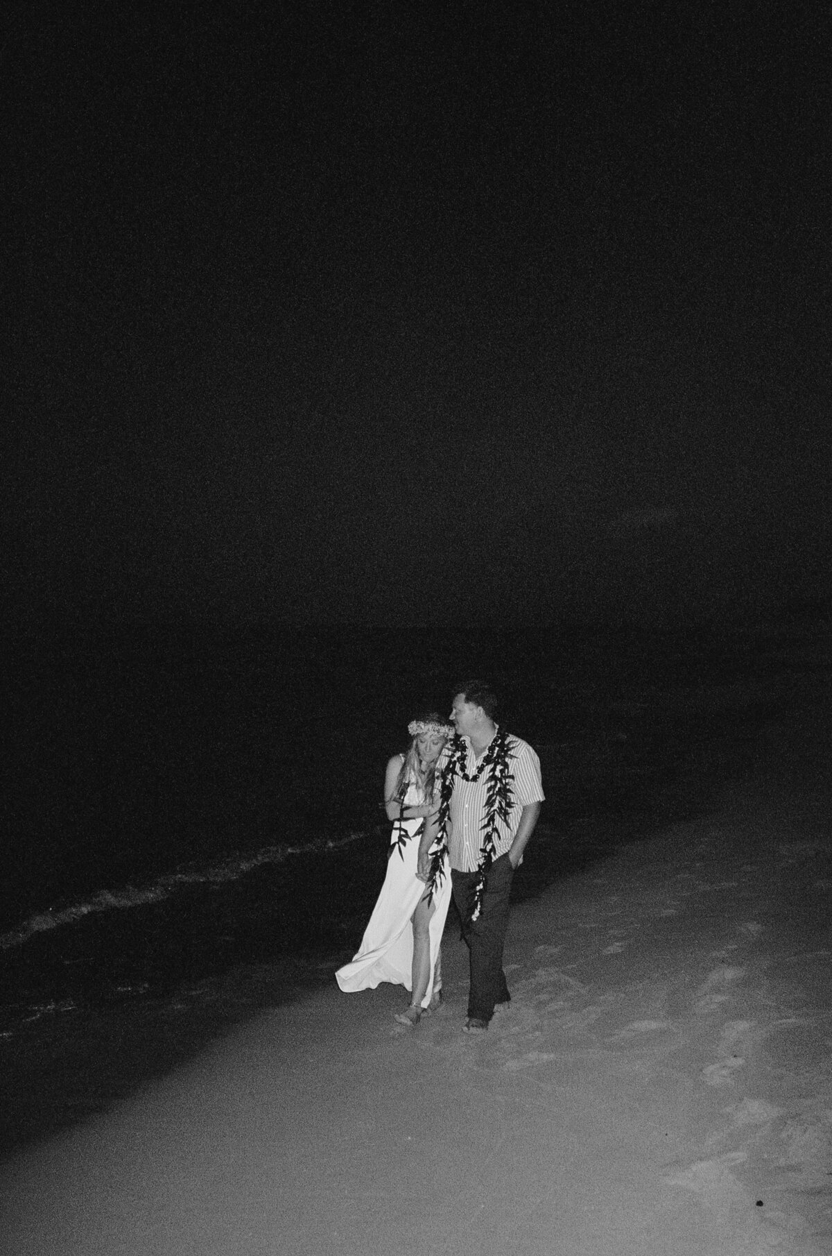 Couple walking along the beahc for California wedding