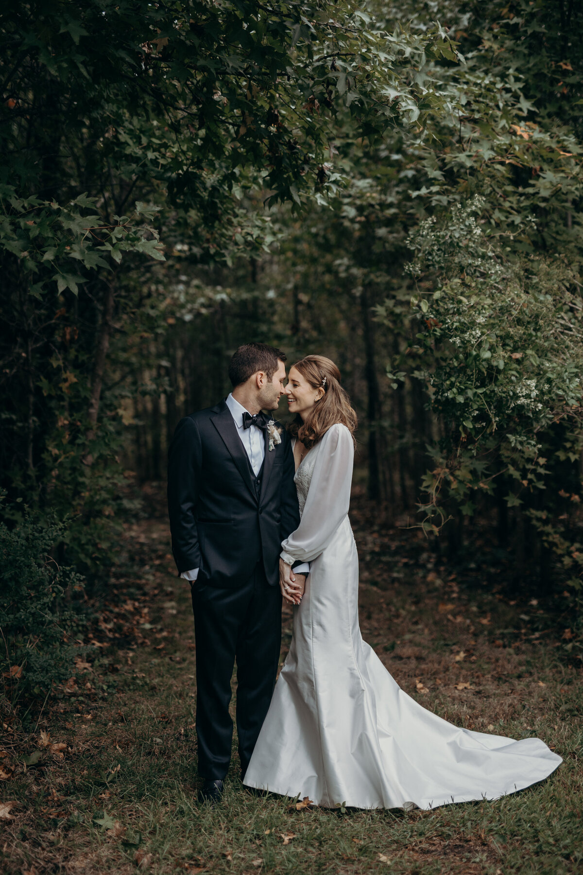 Wedding portrait of a bride and groom in a green garden.