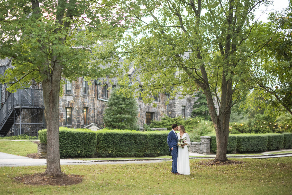 Couple kissing during wedding photos at Homewood Asheville