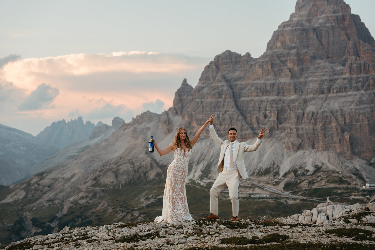 Couple celebrating elopement via helicopter with views of Cadini di Misurina