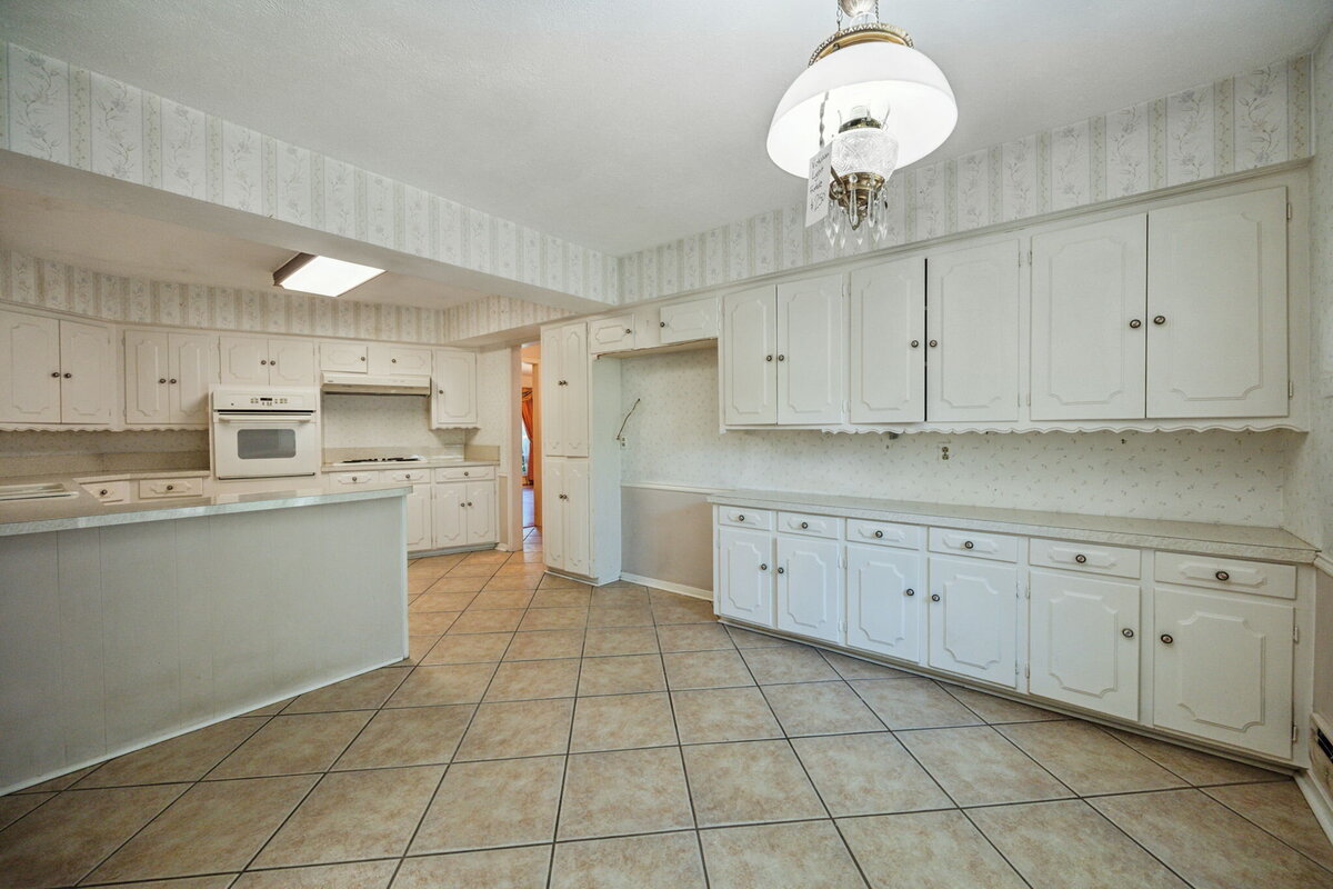 14214_edgecrest_dr_dallas_tx_kitchen_-vintage_white_kitchen_with_extended_cabinetry_and_tile_floors-_haven_realty_group