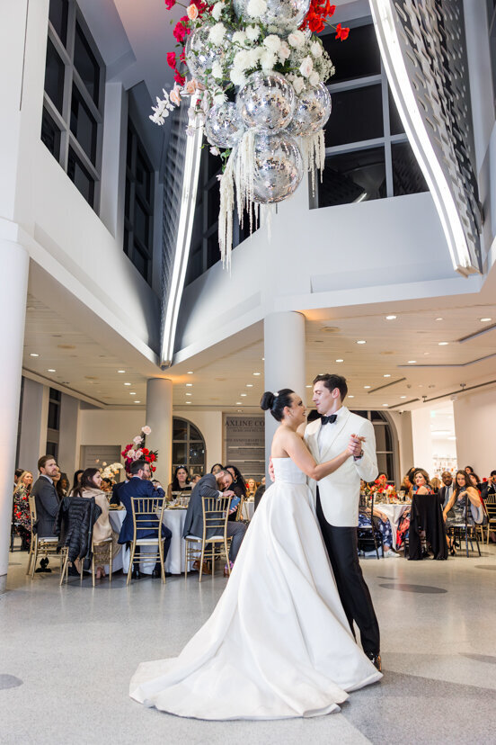 bride-and-groom-dancing-under-disco-balls-at-museum-of-contemporary-arts-san-diego-wedding