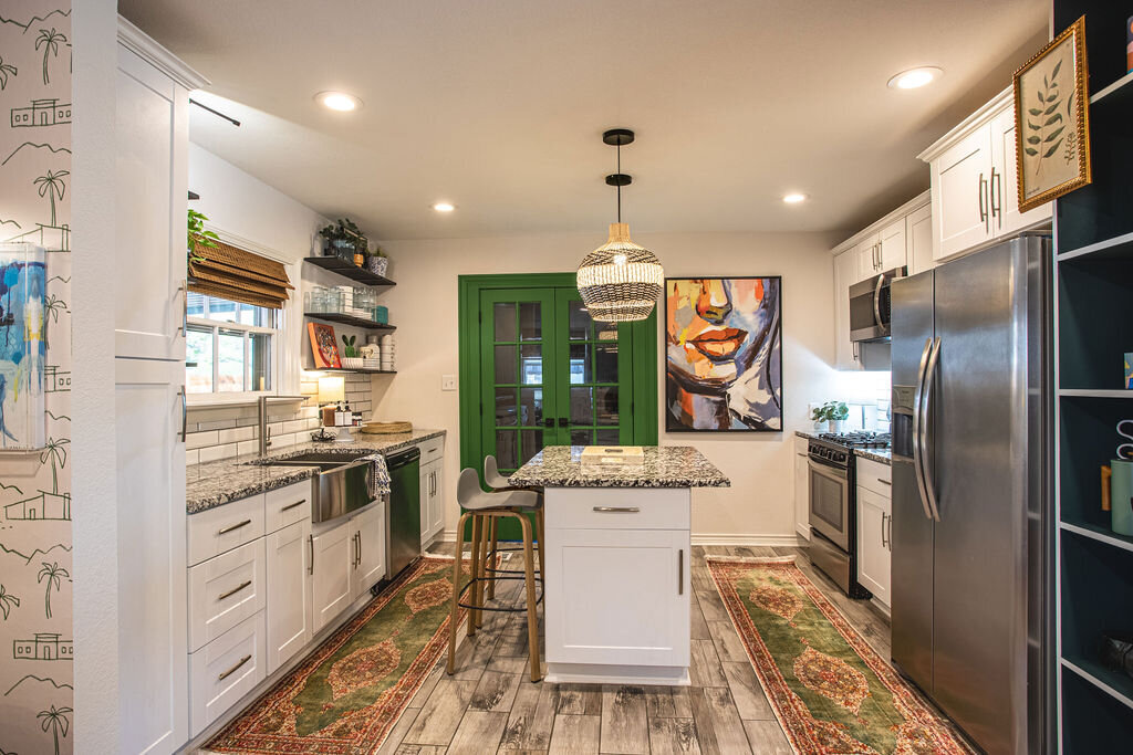 Fully stocked gourmet kitchen with island seating in this three-bedroom, two-bathroom mid-century house that sleeps 8 and boasts a unique experience in color, style, and lifestyle products located in the heart of Waco, TX.