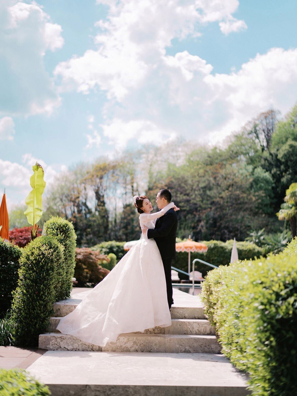 Poolside wedding portraits of a couple during Grand Hotel Tremezzo wedding, by Lake Como Wedding Photographer Andreas K. Georgiou