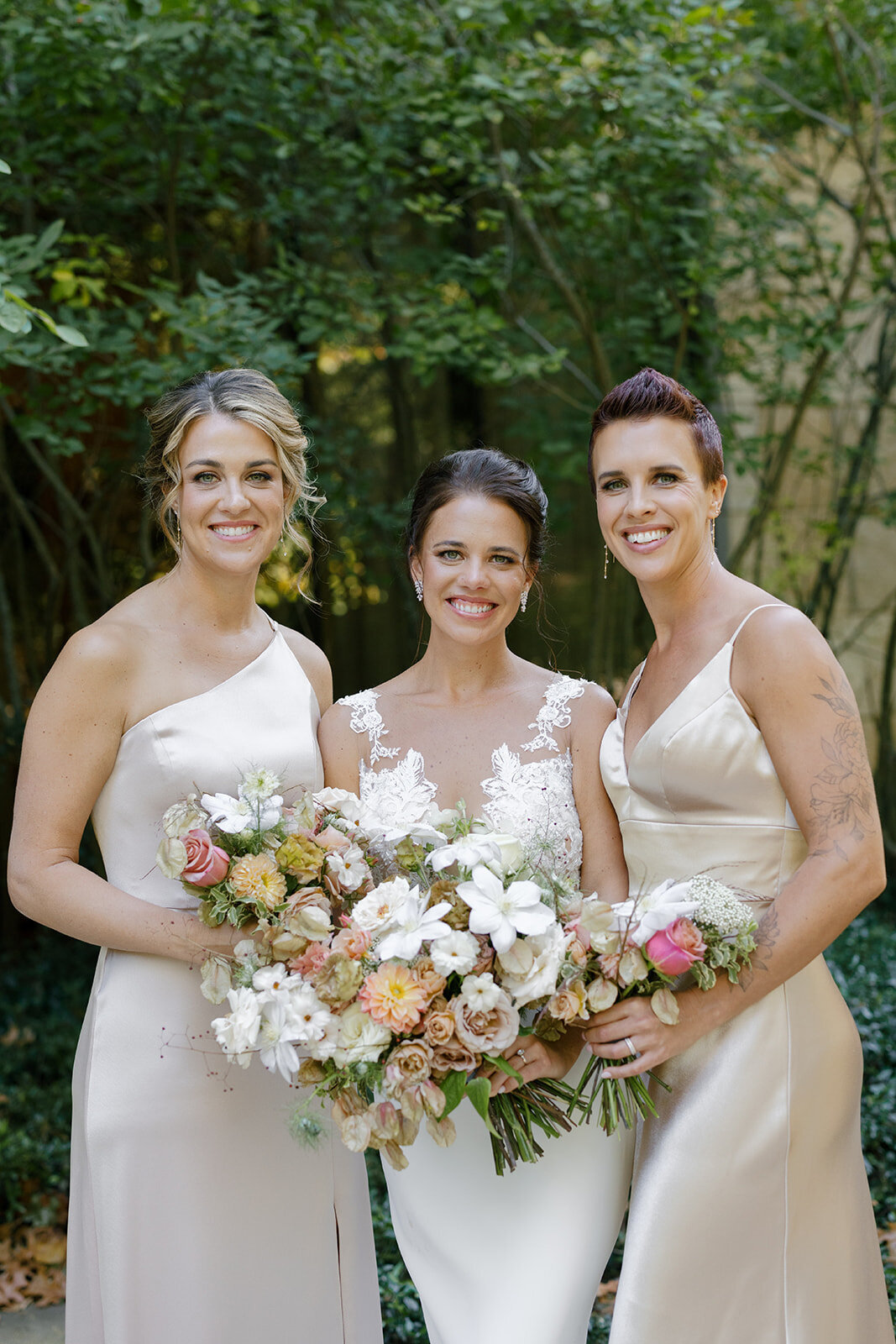 Fall bridesmaids’ bouquets with lush autumnal colors of mauve, dusty pink, cream, white, peach, taupe, and green. Florals of dahlias, roses, clematis, lisianthus, and natural greenery. Fall wedding in Raleigh, NC. Design by Rosemary and Finch Floral Design in Nashville, TN.