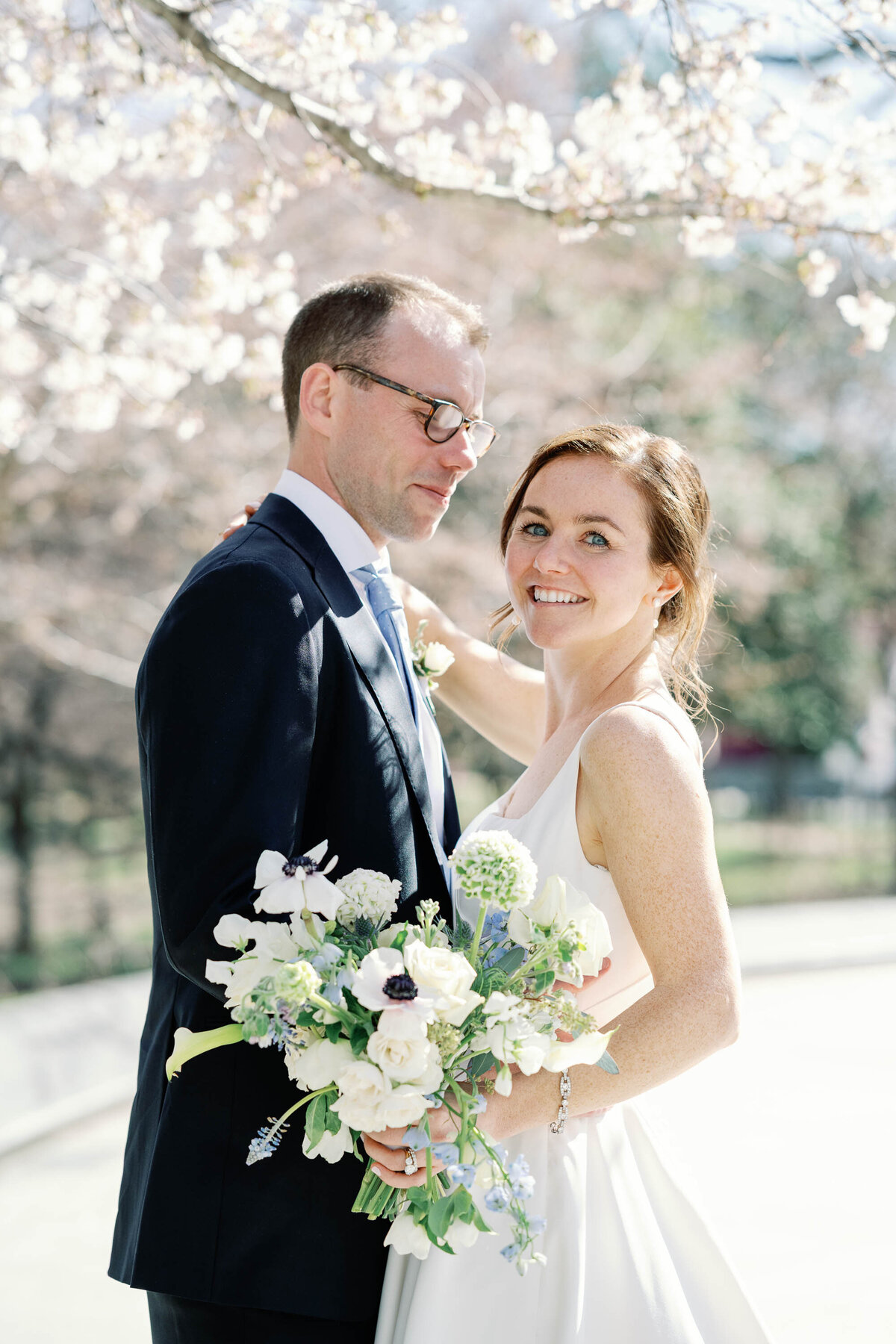 bride and groom at Washington DC MLK monument wedding with cherry blossoms