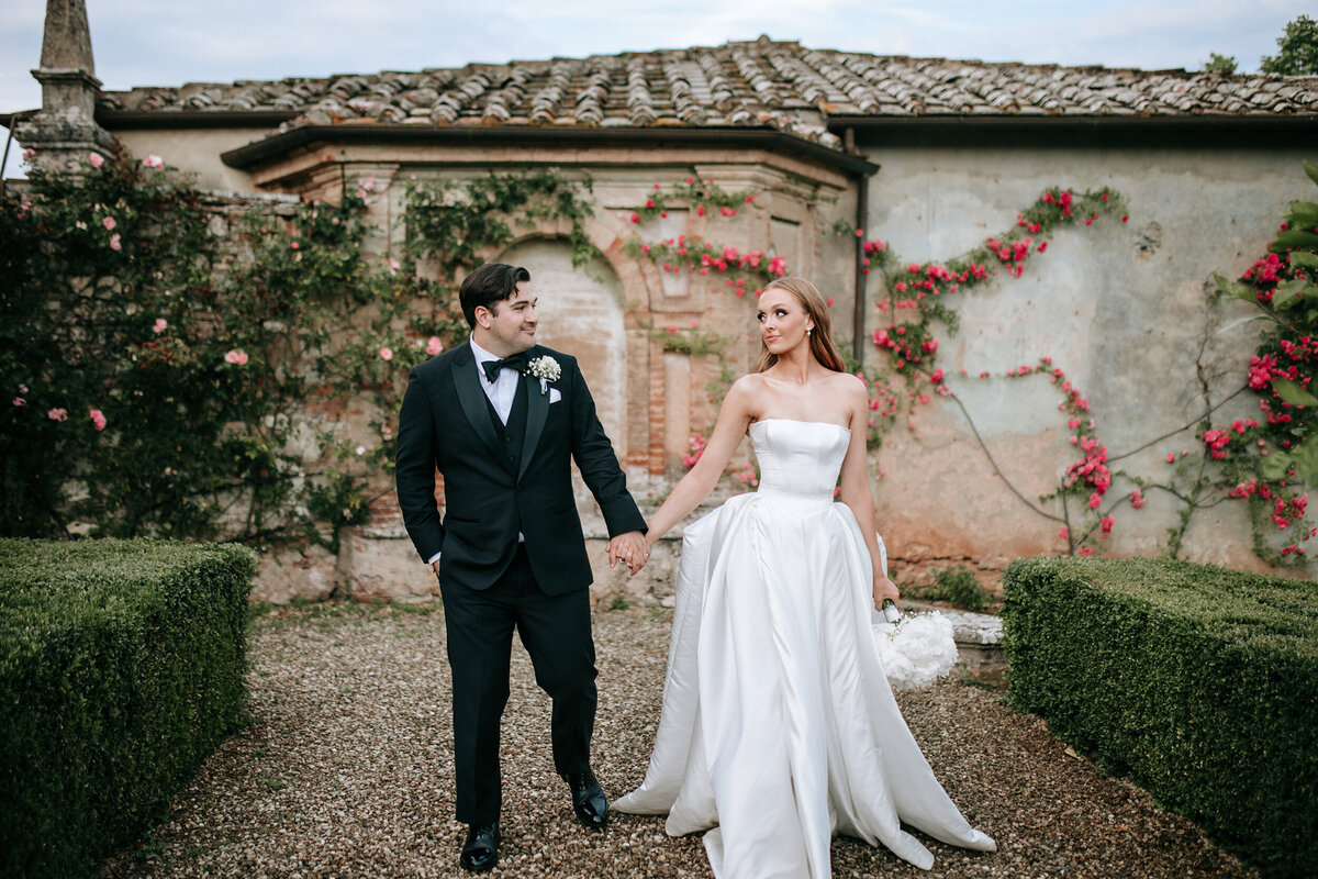 Bride and groom walking photo in Tuscany