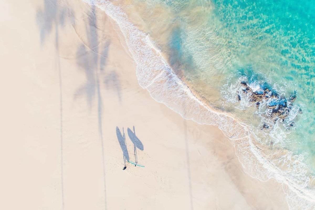 Unique drone image of couples Love + Water engagement session on Maui