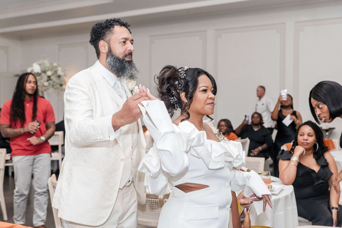 The couple embraces on the dance floor, lost in the joy of their first dance as newlyweds.