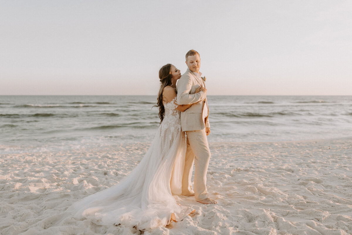 newlyweds walk on beach