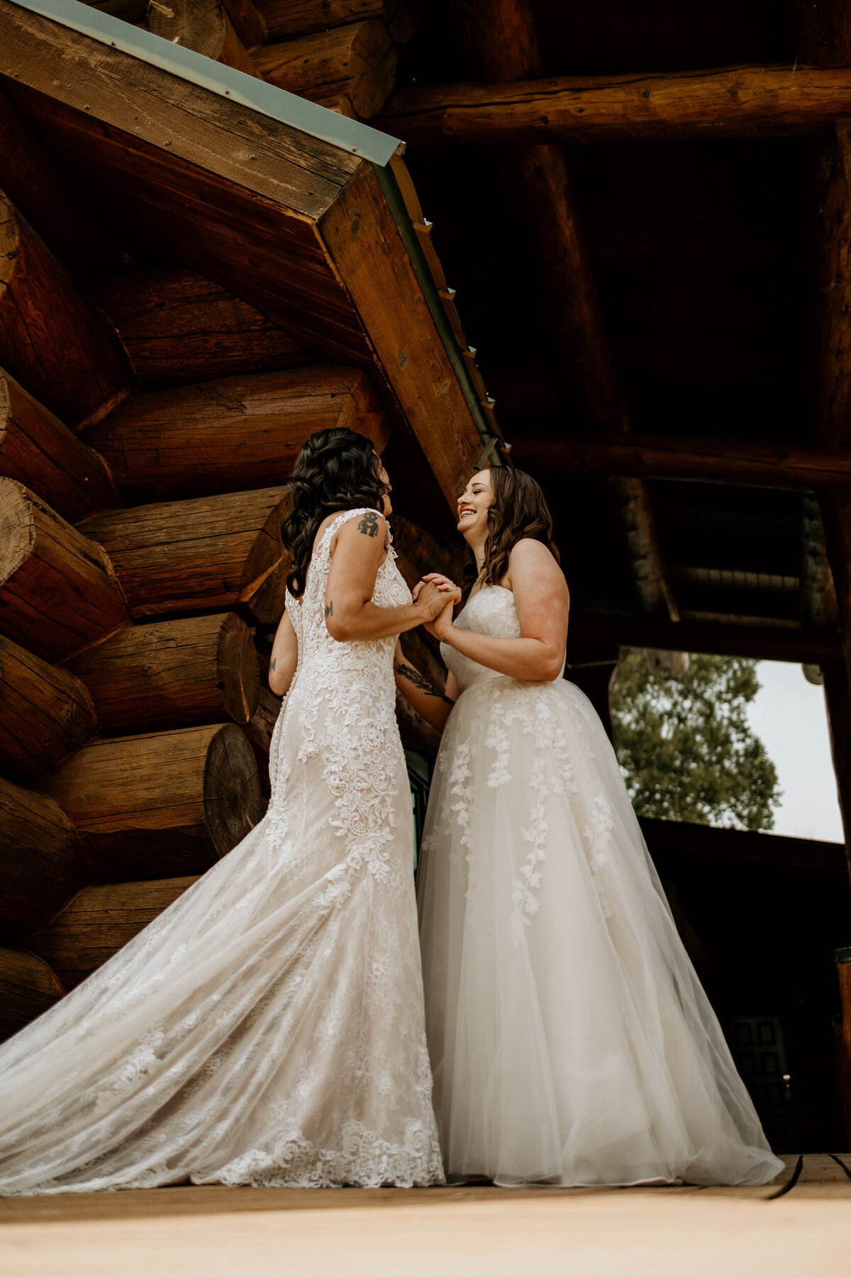 same sex couple in their wedding dresses having  a first look